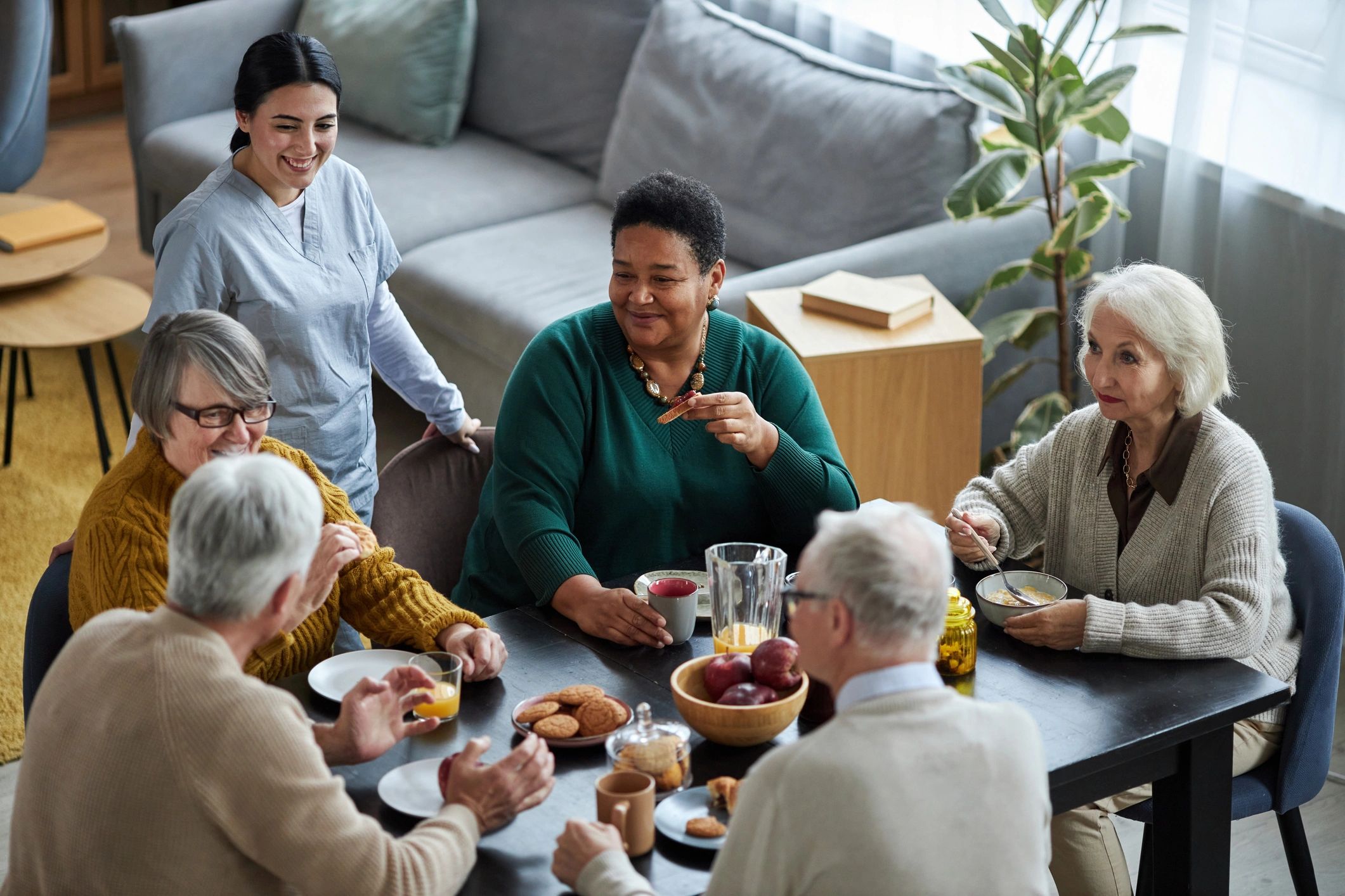 Residents seated together at a dining table in a communal room