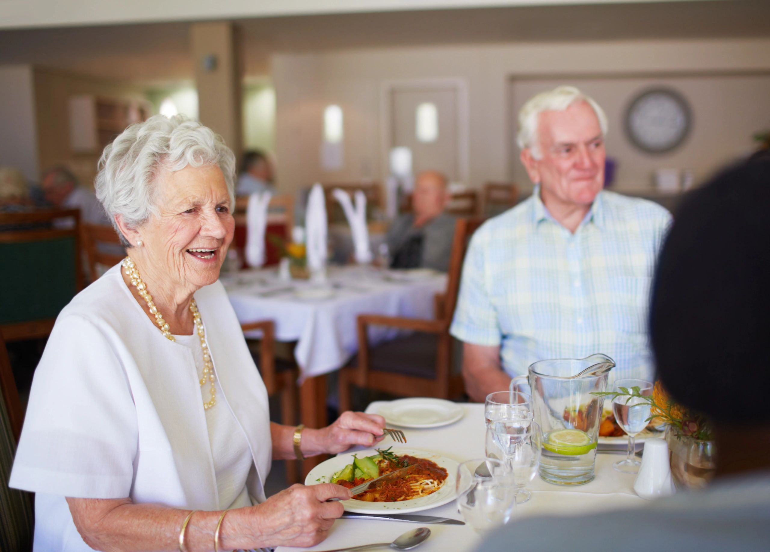 Residents chatting and smiling at lunchtime