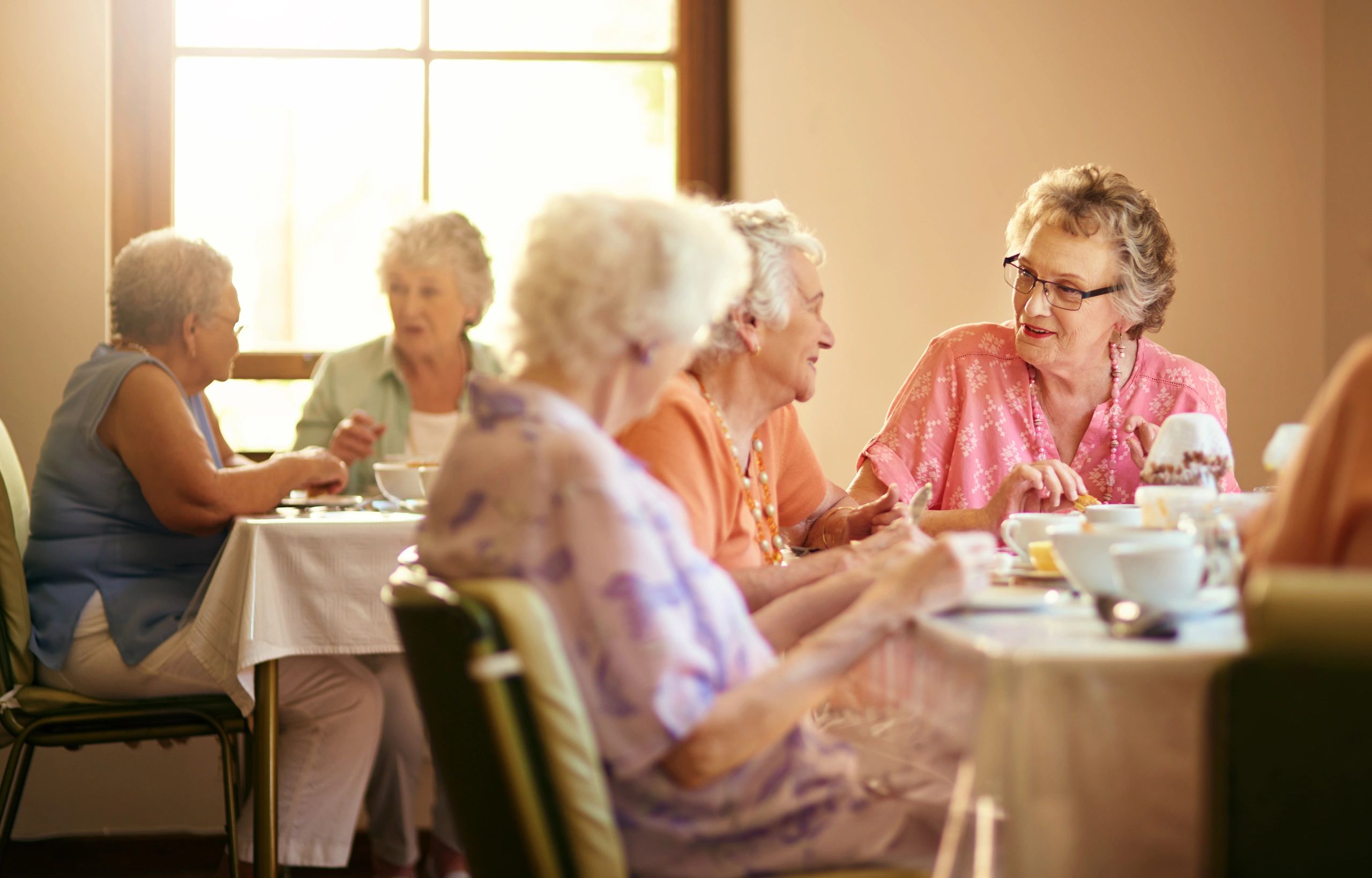 Group of seniors having tea together.