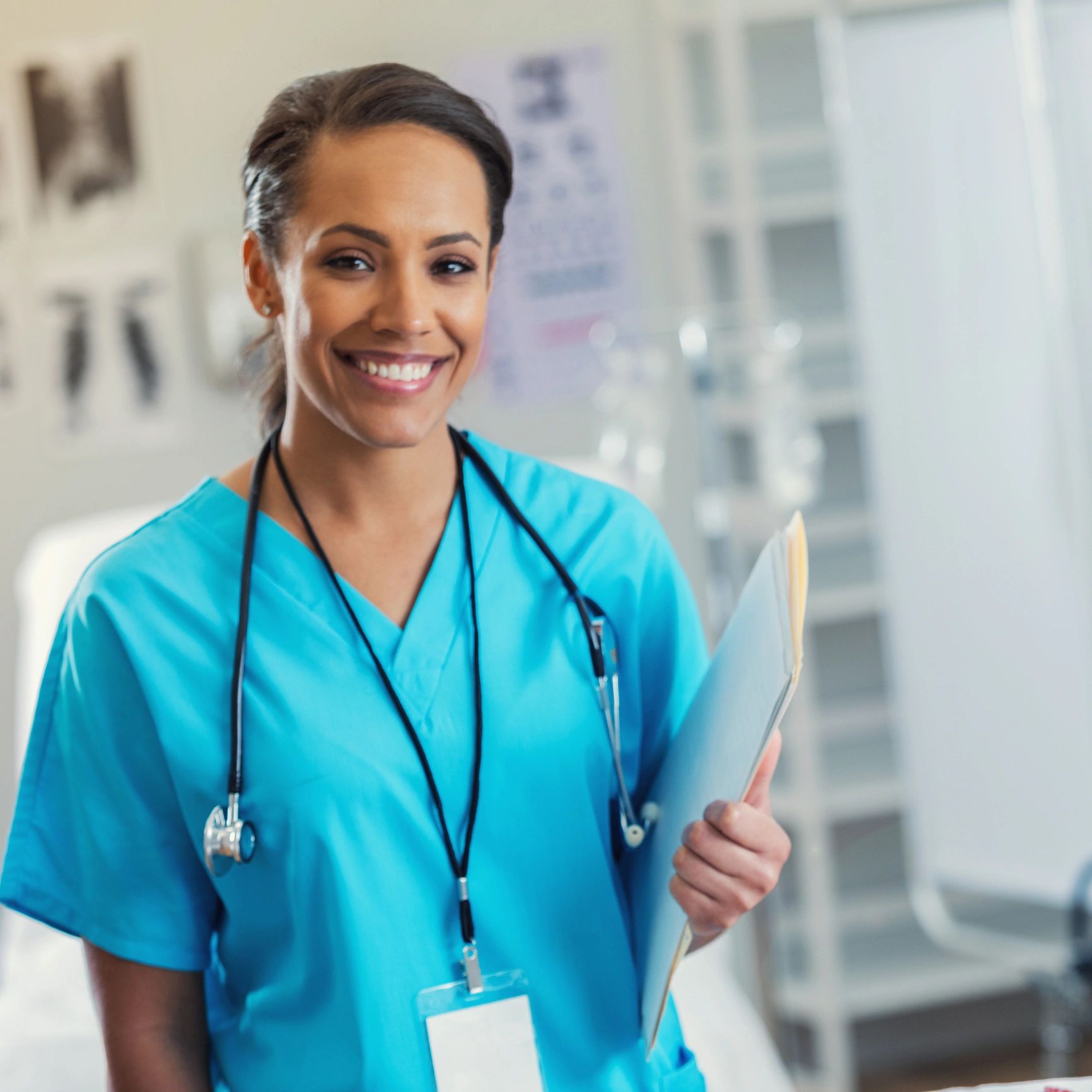 Portrait of a nurse holding a patient chart
